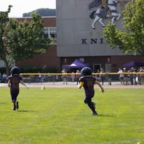 Two Titans football players running on the field together