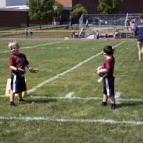 Two young Titans flag football players on the field