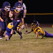 Titans football players making a tackle at night