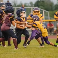 Titans football player carrying the ball through defenders