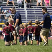 Titans coaches and young players gathered on the field