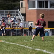 Young Titans football player running on the field