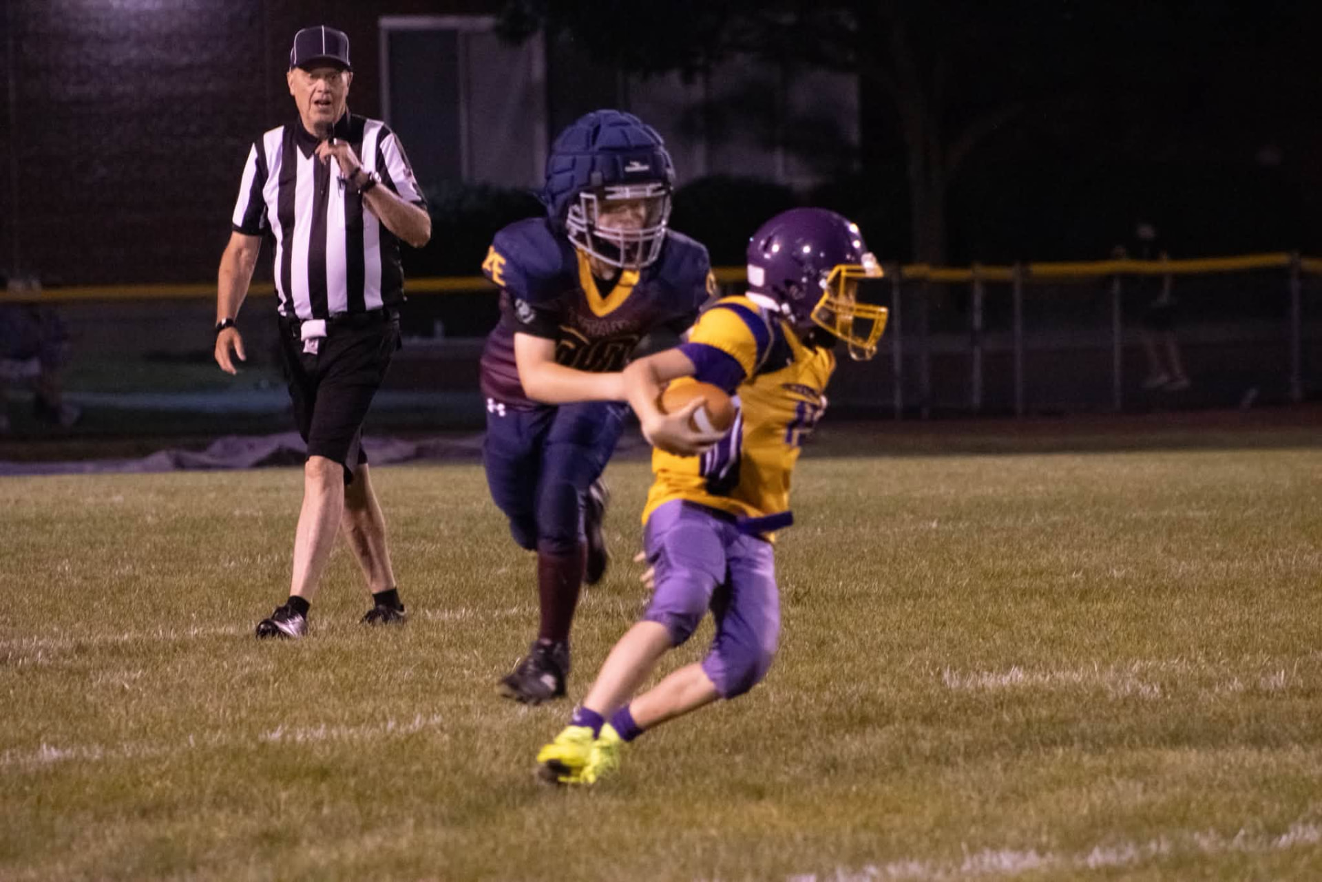 Titans defender chasing down a ball carrier under the lights