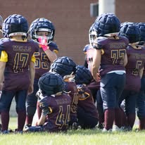 Titans players in helmets huddled up during a game