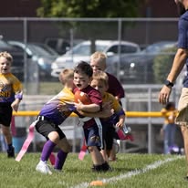 Young flag football players making a tackle