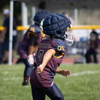 Titans football player in helmet running on the field