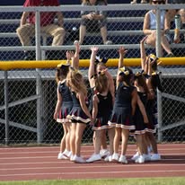 Titans cheerleaders raising their arms on the track
