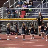 Titans cheerleaders lined up on the track with a coach