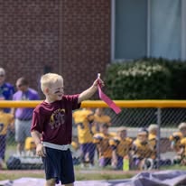Young Titans flag football player waving a flag