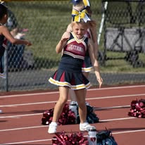 Titans cheerleader with pom-poms on the track