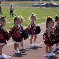 Young Titans cheerleaders performing on the track
