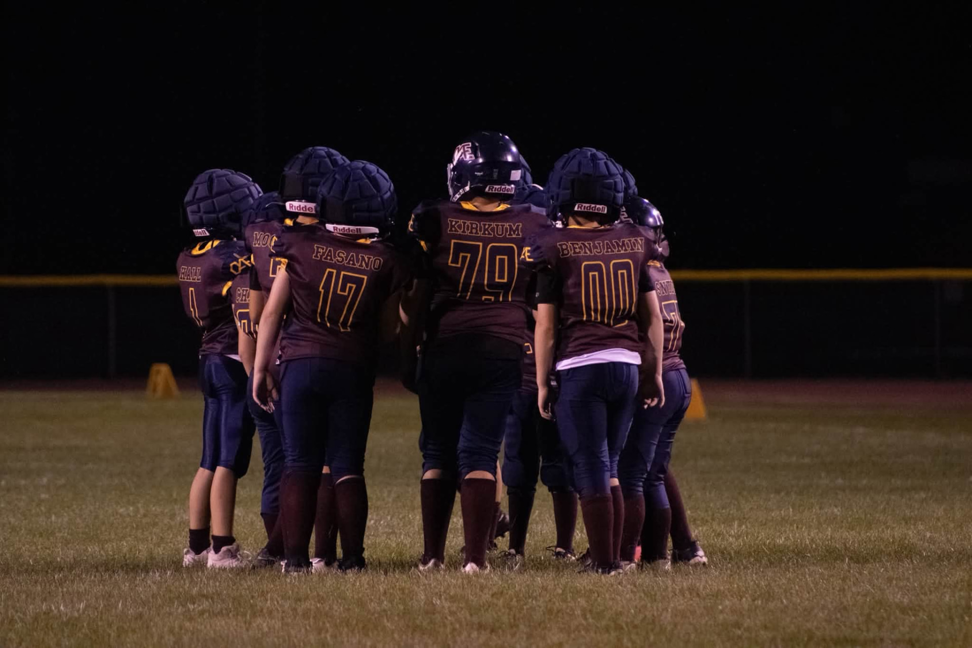 Titans offense huddled together during a night game