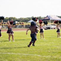 Titans football player running past cheerleaders on the field