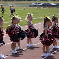 Young Titans cheerleaders lined up on the track