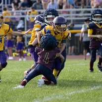 Titans players tackling a ball carrier