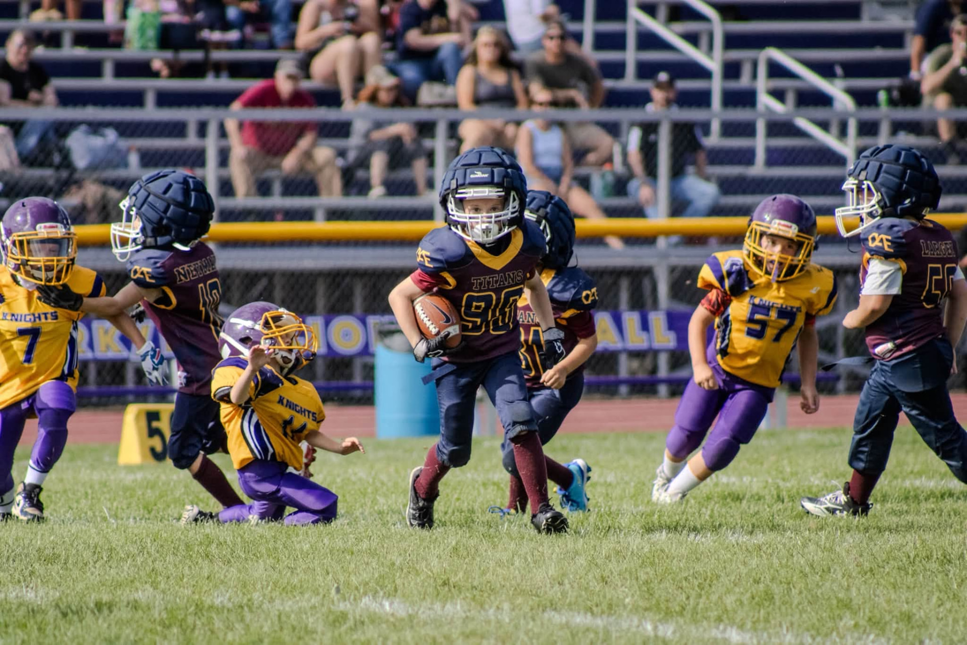 Titans number 90 running the ball through traffic