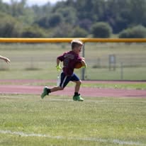 Young Titans ball carrier running down the field