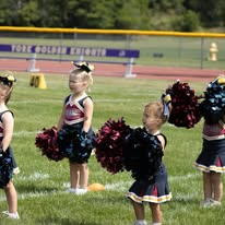 Titans cheerleaders holding pom-poms on the field