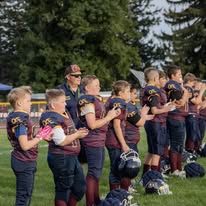 Titans football team lined up with a coach on the field