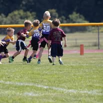 Young Titans flag football players running during a game