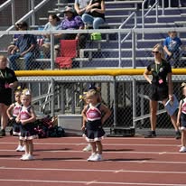 Titans cheerleaders on the track with coaches nearby