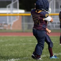 Young Titans football player in full gear on the field