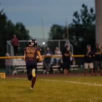 Titans football player running toward the end zone at dusk