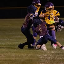 Titans players making a tackle under the lights