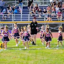 Titans cheerleaders and a coach on the field