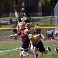 Young Titans flag football player running with the ball