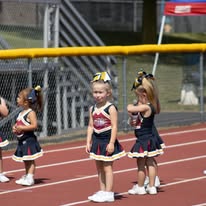 Three young Titans cheerleaders on the track