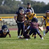 Titans defenders tackling a ball carrier