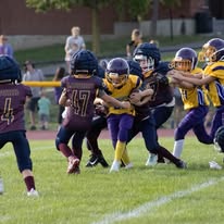 Young Titans football players making a tackle during a game