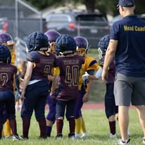 Titans football team huddled with their head coach