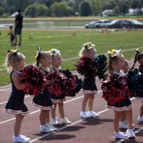 Line of young Titans cheerleaders with pom-poms on the track