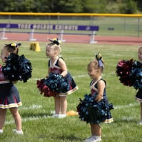 Group of young Titans cheerleaders with pom-poms on the field