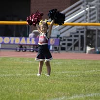 Titans cheerleader with pom-poms raised on the field