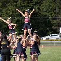 Titans cheerleaders lifting a teammate in a stunt