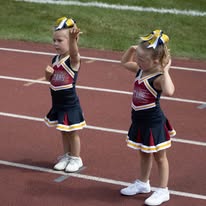 Two young Titans cheerleaders performing on the track
